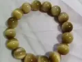 黄金虎眼石手链，顶级的虎眼石，颗颗带猫眼效应，实物更漂亮。义顺自取。